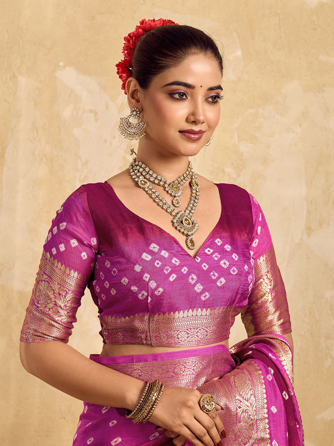 a red and pink Viscos silk bandhani saree with zari border and a pink blouse