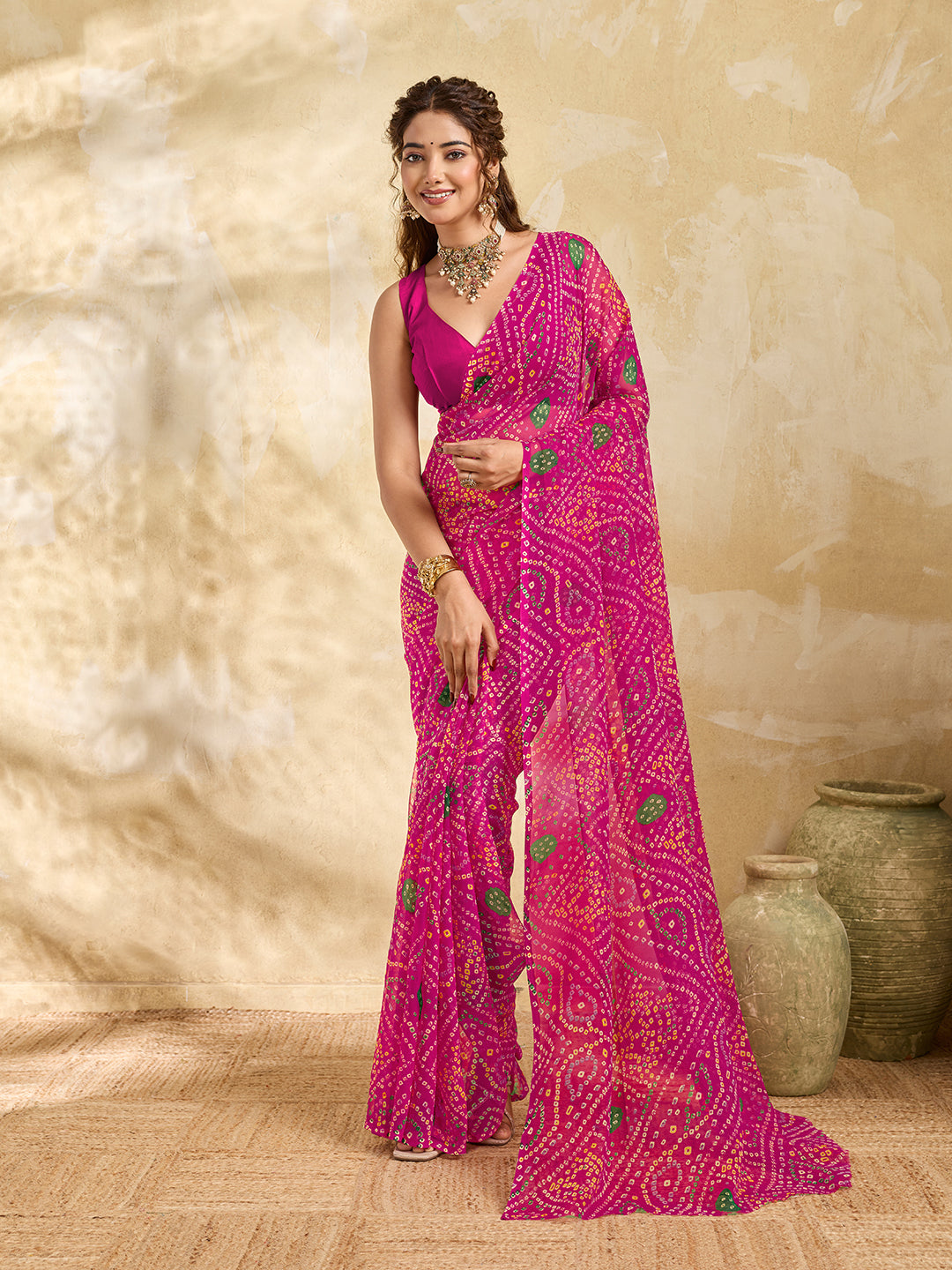 A rani colour geometric patterned saree with bandhani style dots under 500