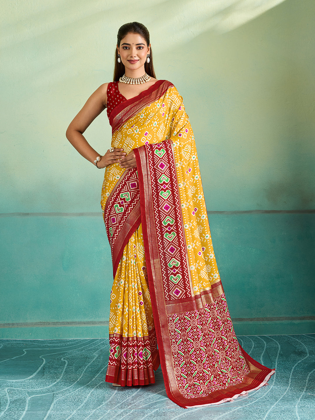 A yellow and red pashmina cotton silk saree with a patola style pattern