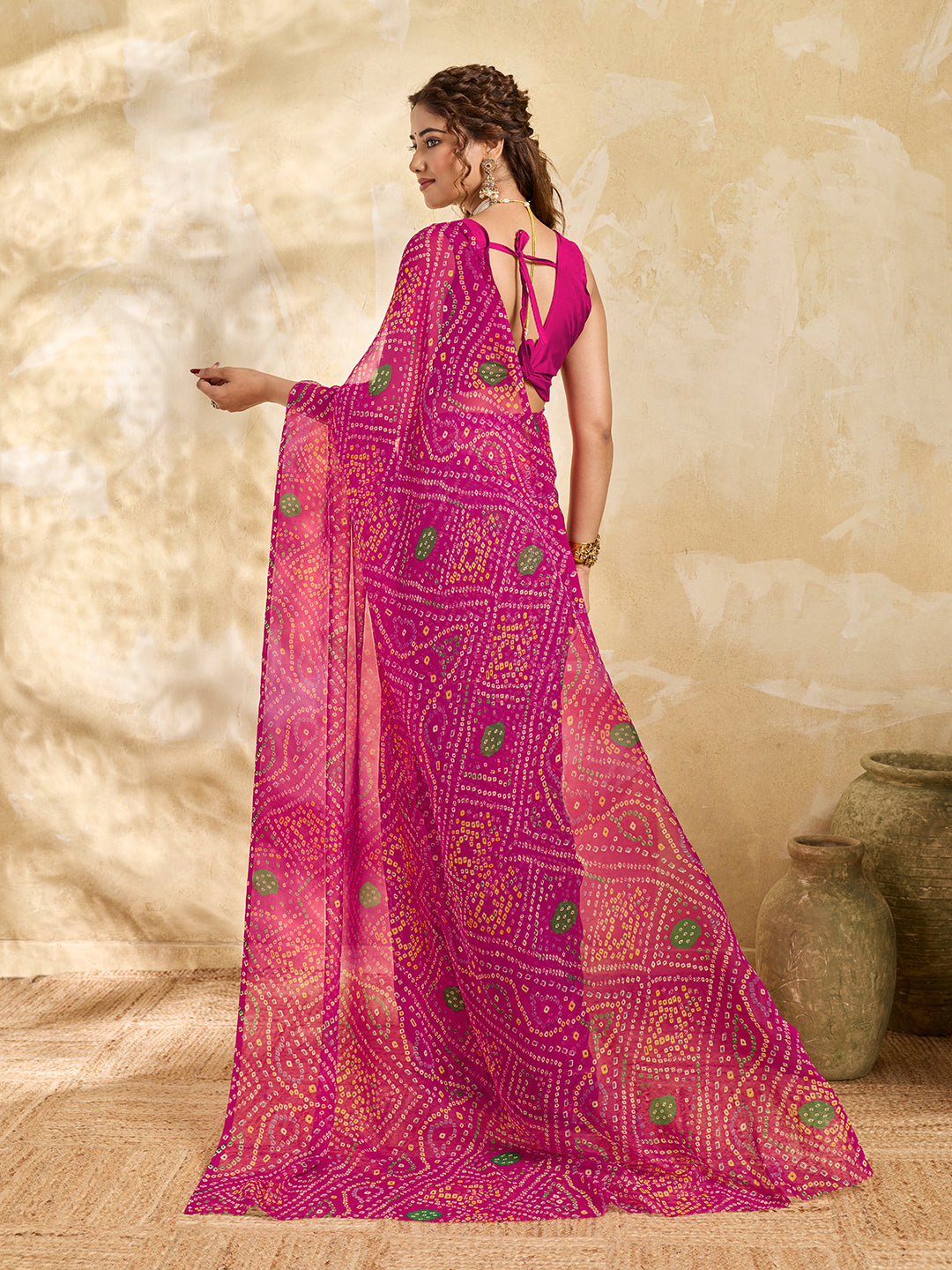 A rani colour geometric patterned saree with bandhani style dots under 500