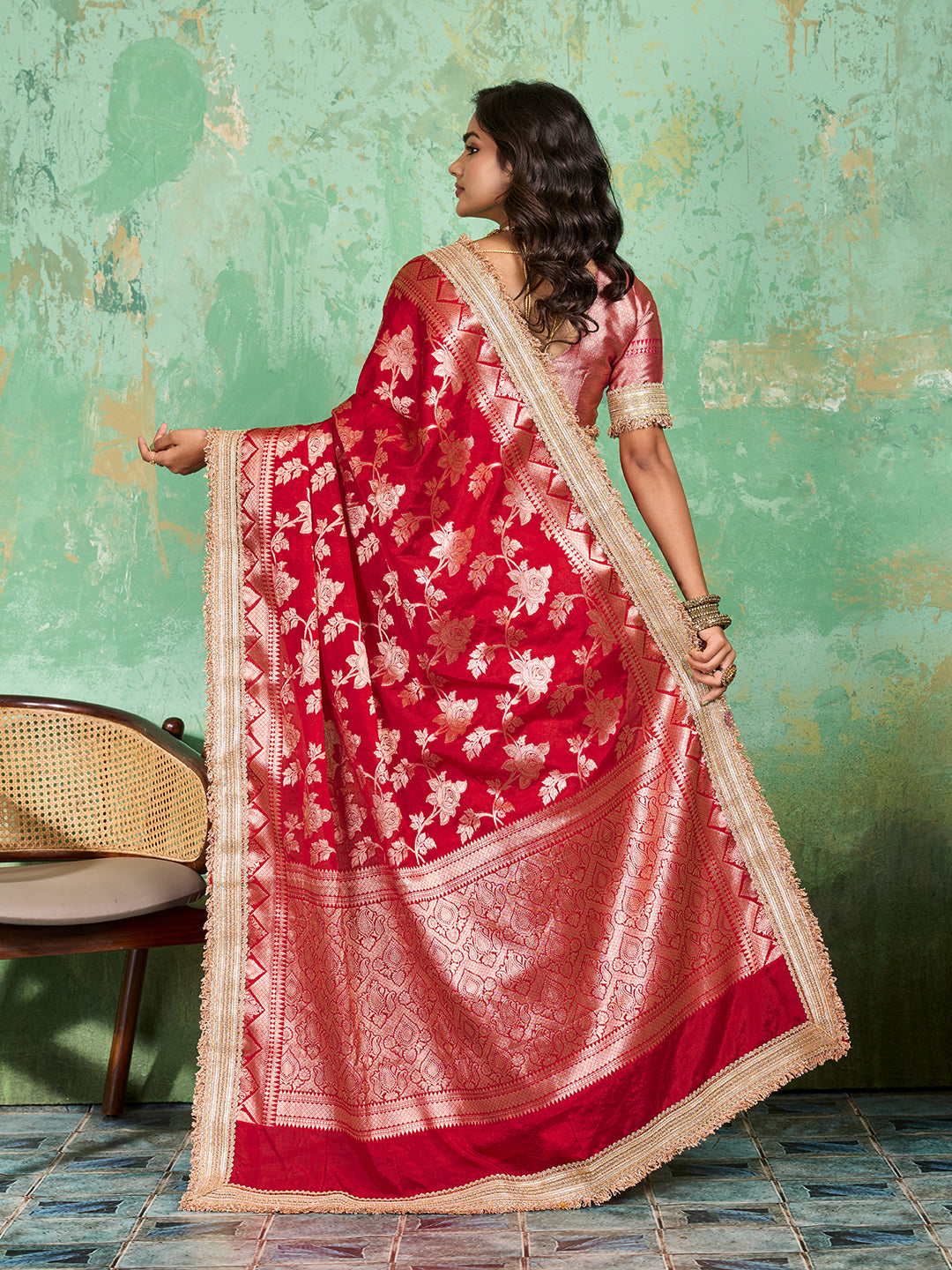 Woman in a red saree with gold borderTissue silk Banarasi Style