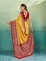 A yellow and red pashmina cotton silk saree with a patola style pattern