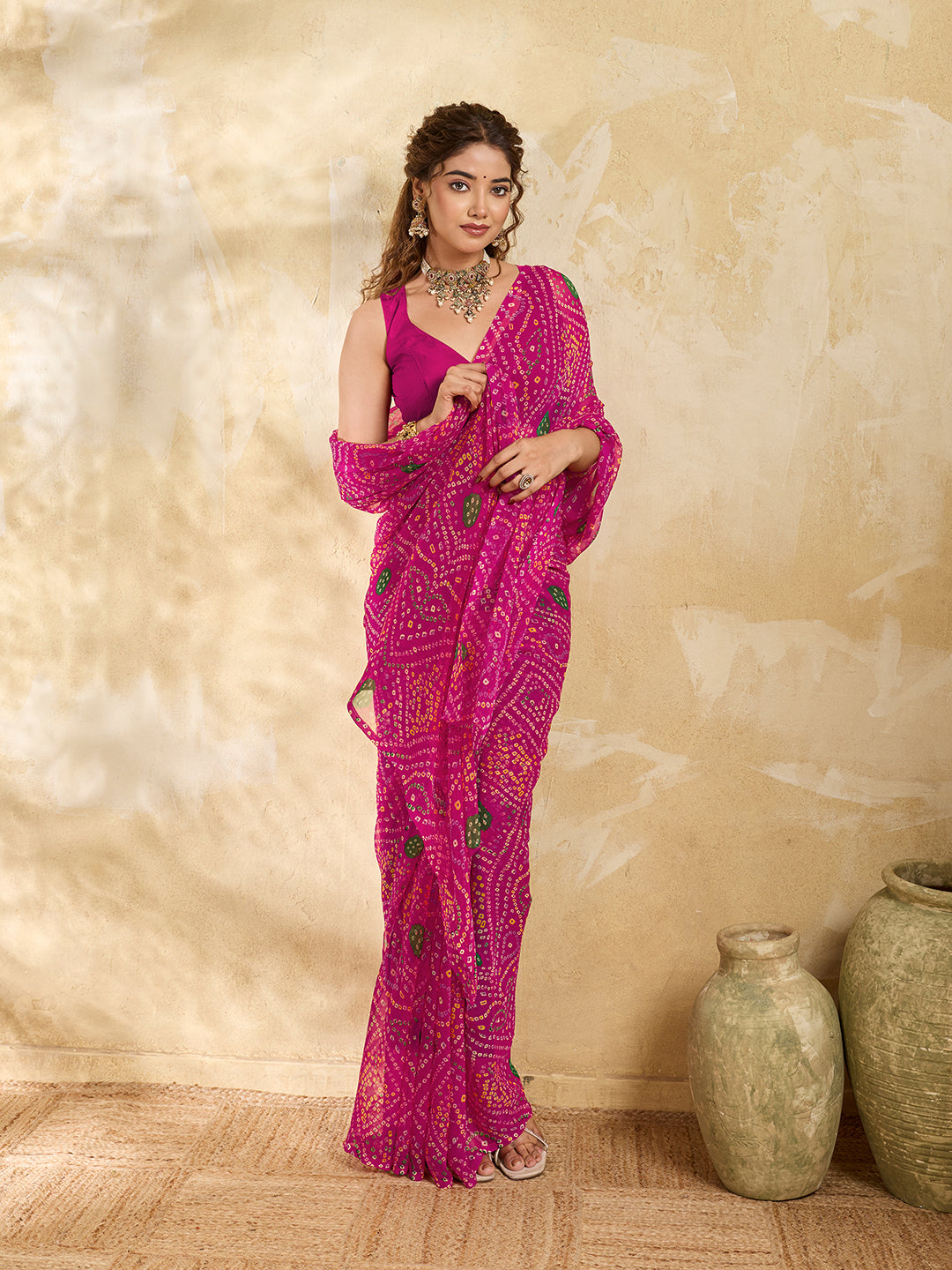 A rani colour geometric patterned saree with bandhani style dots under 500