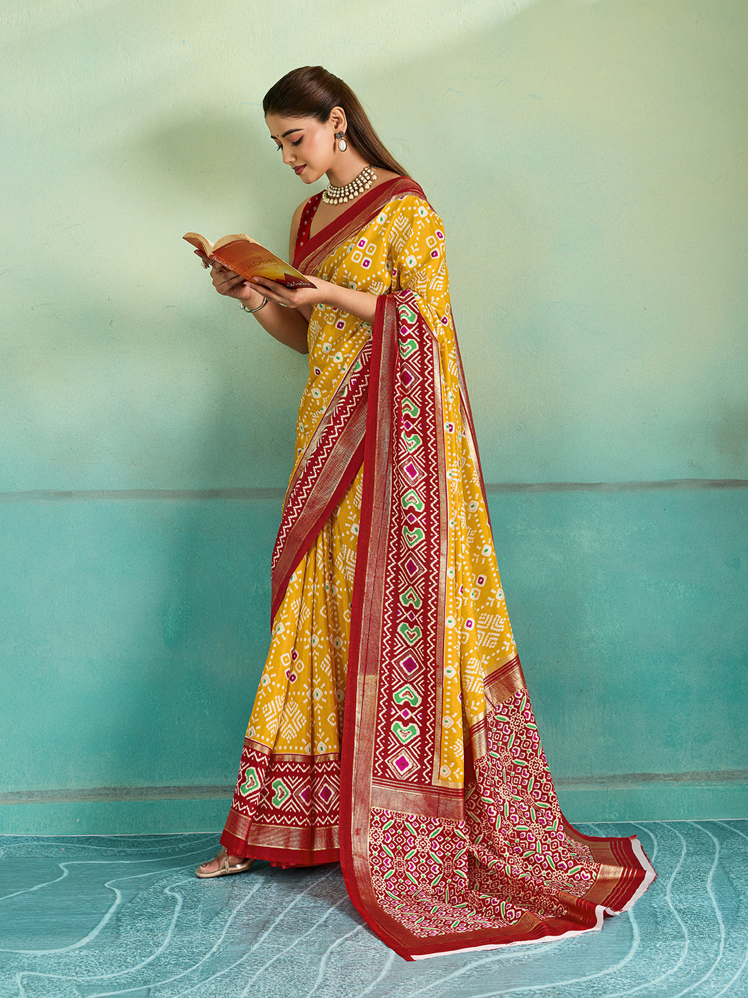 A yellow and red pashmina cotton silk saree with a patola style pattern