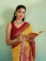 A yellow and red pashmina cotton silk saree with a patola style pattern