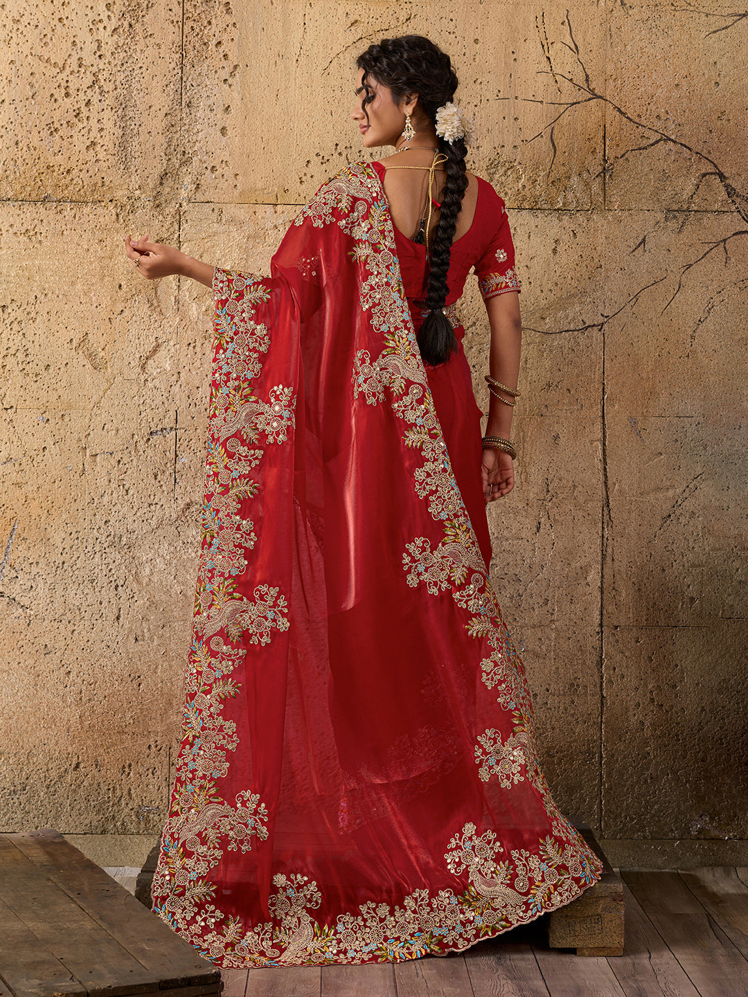 A red saree with floral embroidery