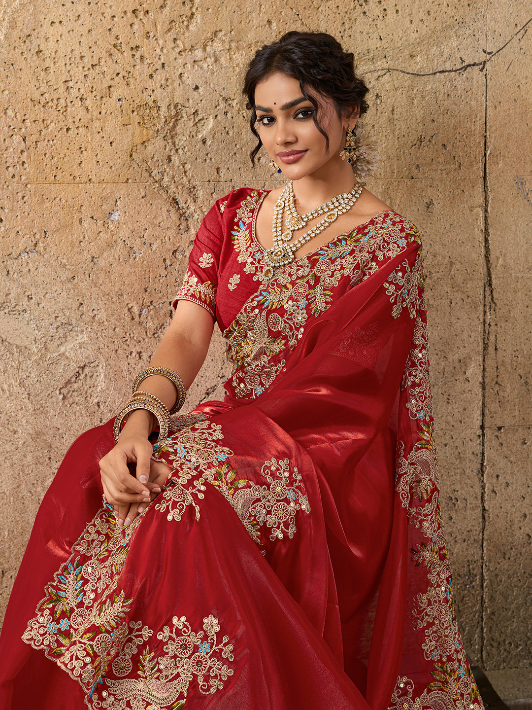 A red saree with floral embroidery