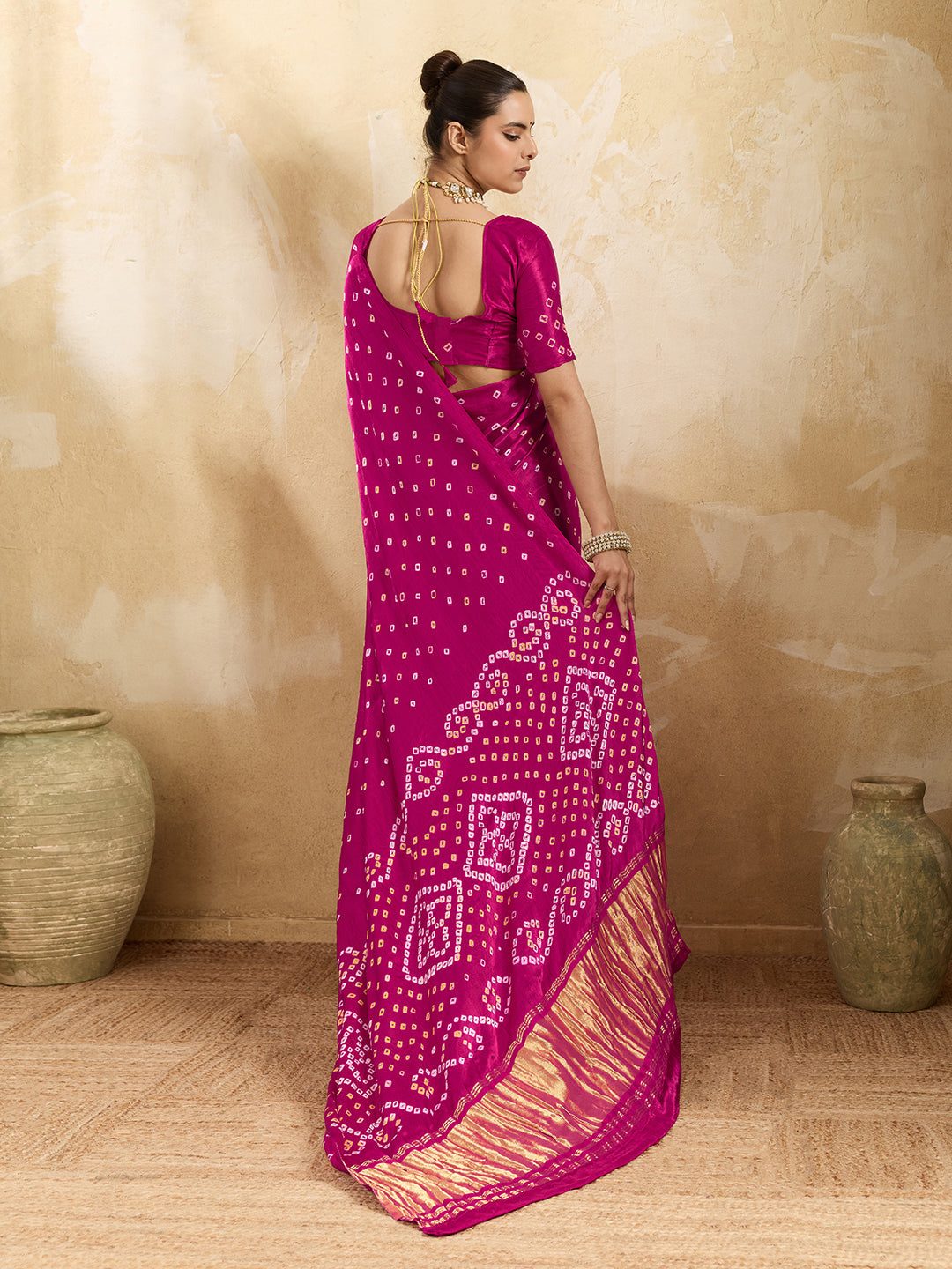 A pink saree with a bandhani pattern and a lagdi pallu design,