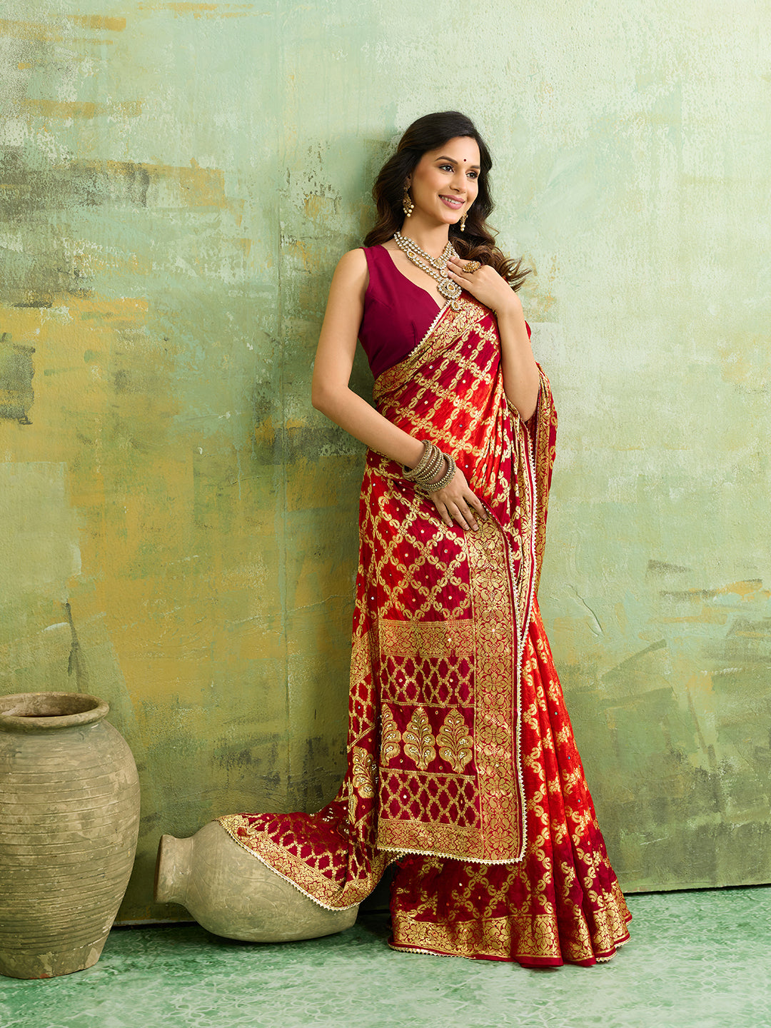 Banarasi silk saree with heavy zari work in orange and red color, with a traditional gharcholastyle