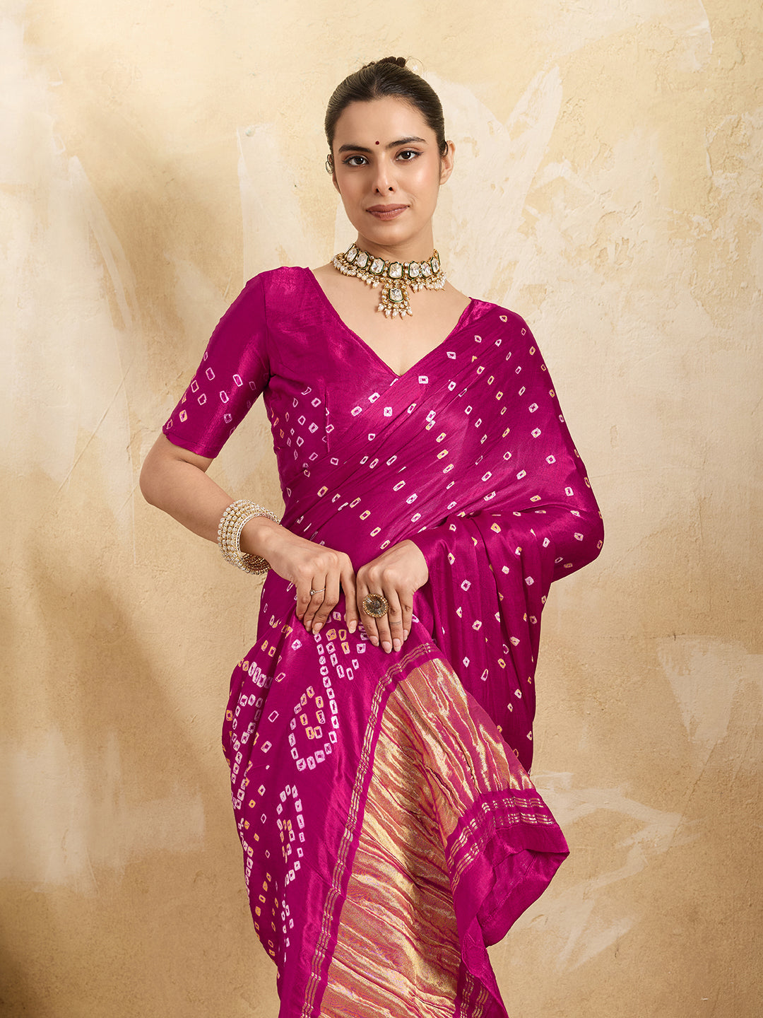 A pink saree with a bandhani pattern and a lagdi pallu design,
