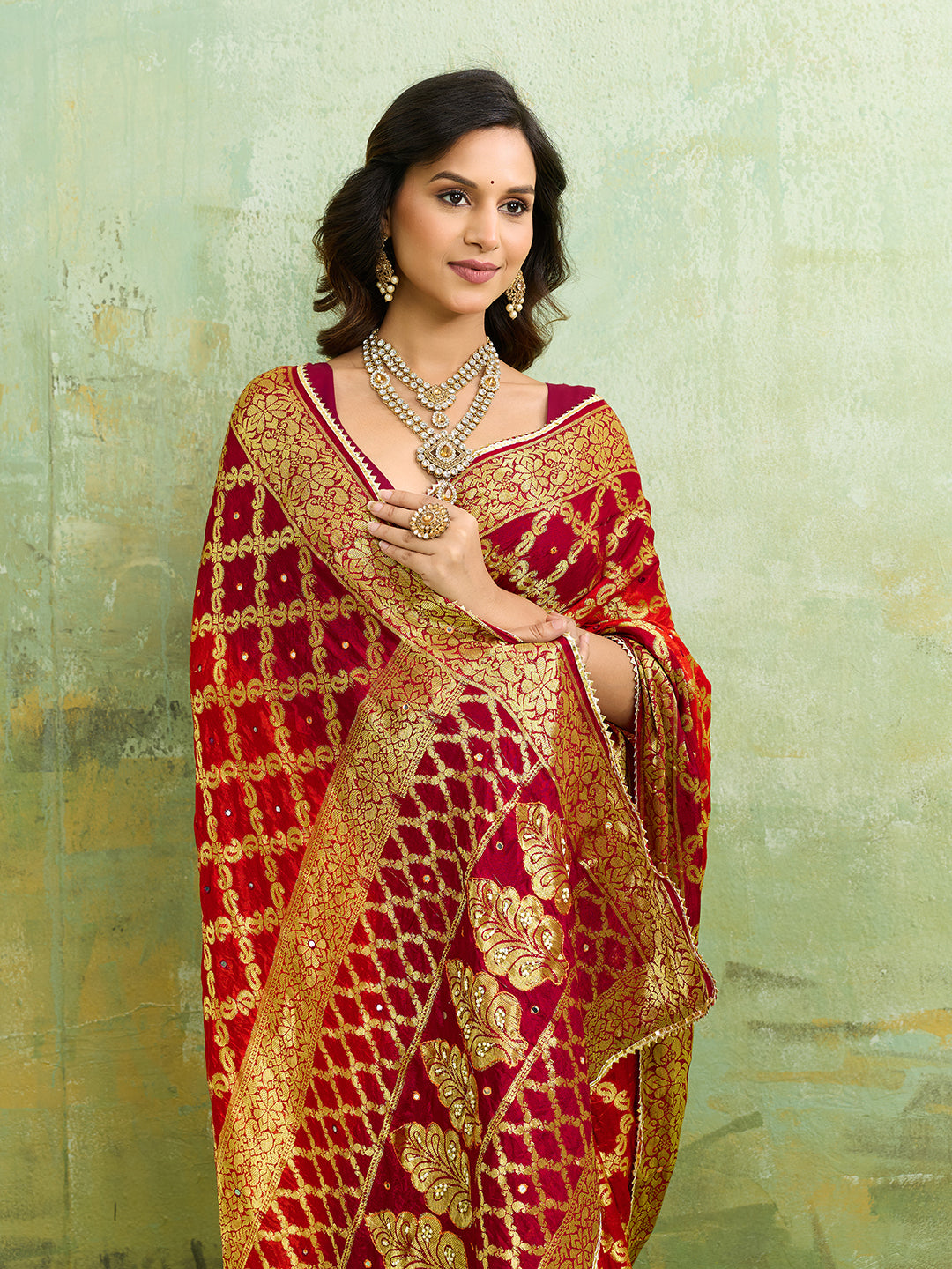Banarasi silk saree with heavy zari work in orange and red color, with a traditional gharcholastyle