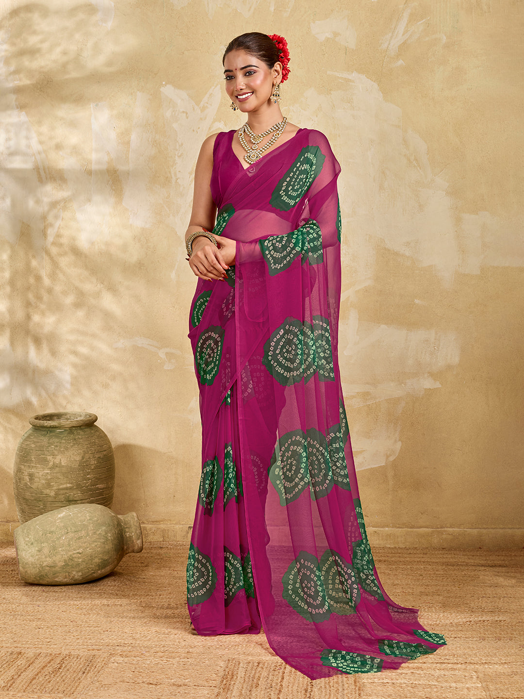 A bright pink saree with bandhani print under 500