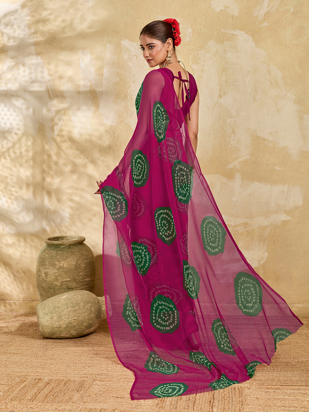 A bright pink saree with bandhani print under 500