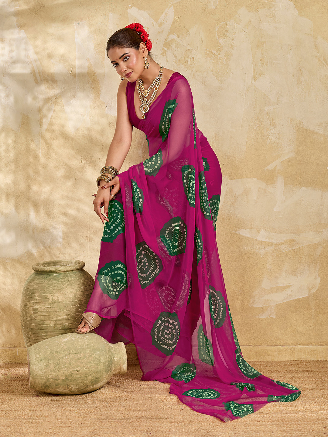 A bright pink saree with bandhani print under 500