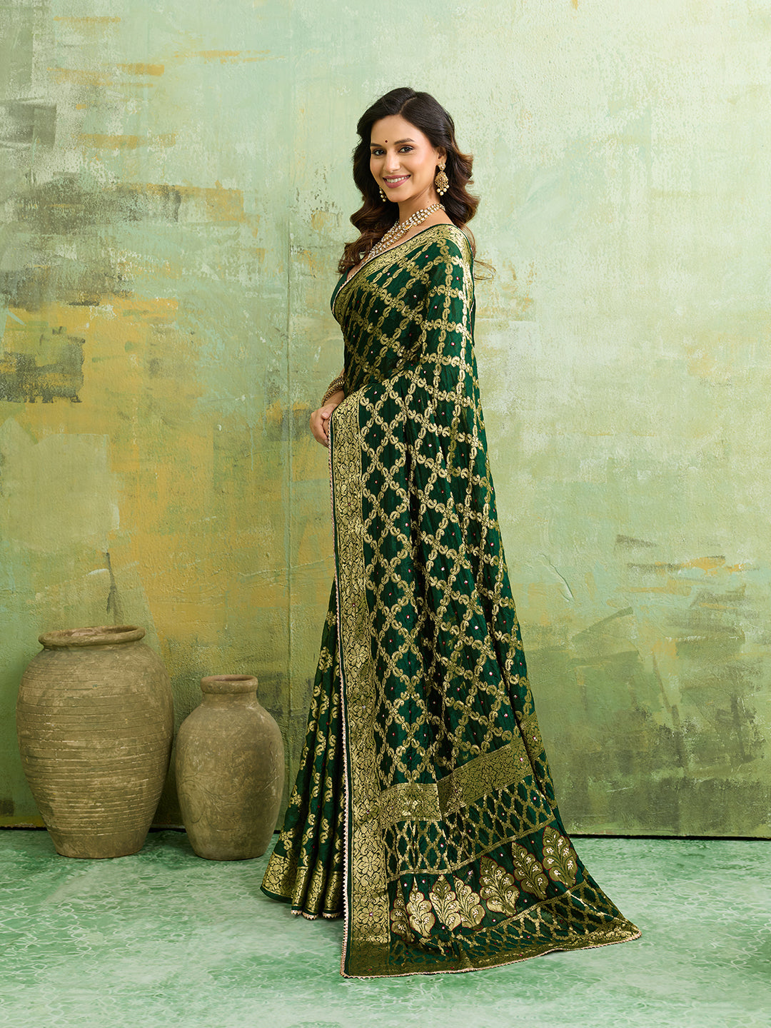 A bottle green Banarasi silk saree with heavy zari work and a gharchola pattern