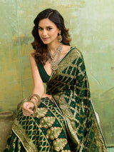 A bottle green Banarasi silk saree with heavy zari work and a gharchola pattern