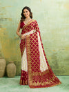 Banarasi silk saree with heavy zari work and a gharchola pattern in white and red colors