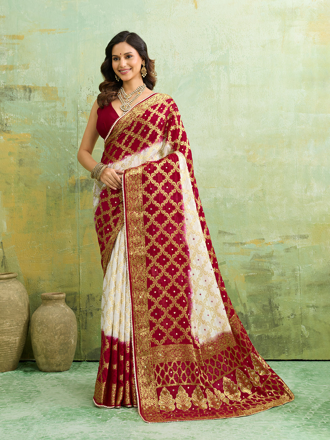 Banarasi silk saree with heavy zari work and a gharchola pattern in white and red colors