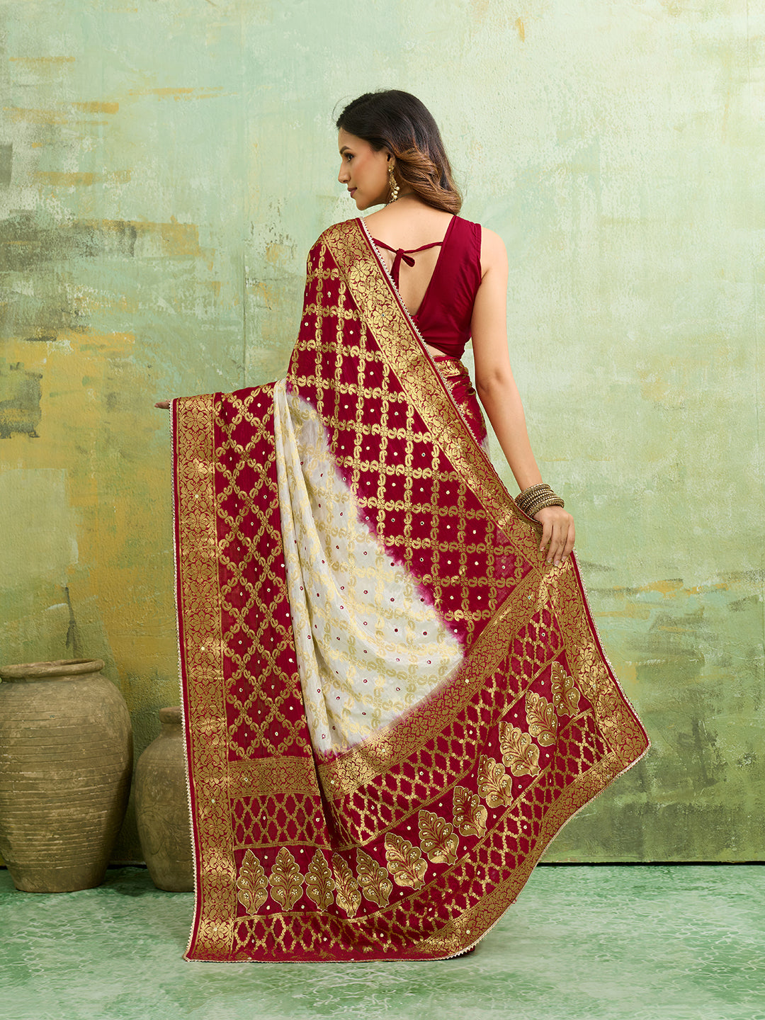 Banarasi silk saree with heavy zari work and a gharchola pattern in white and red colors