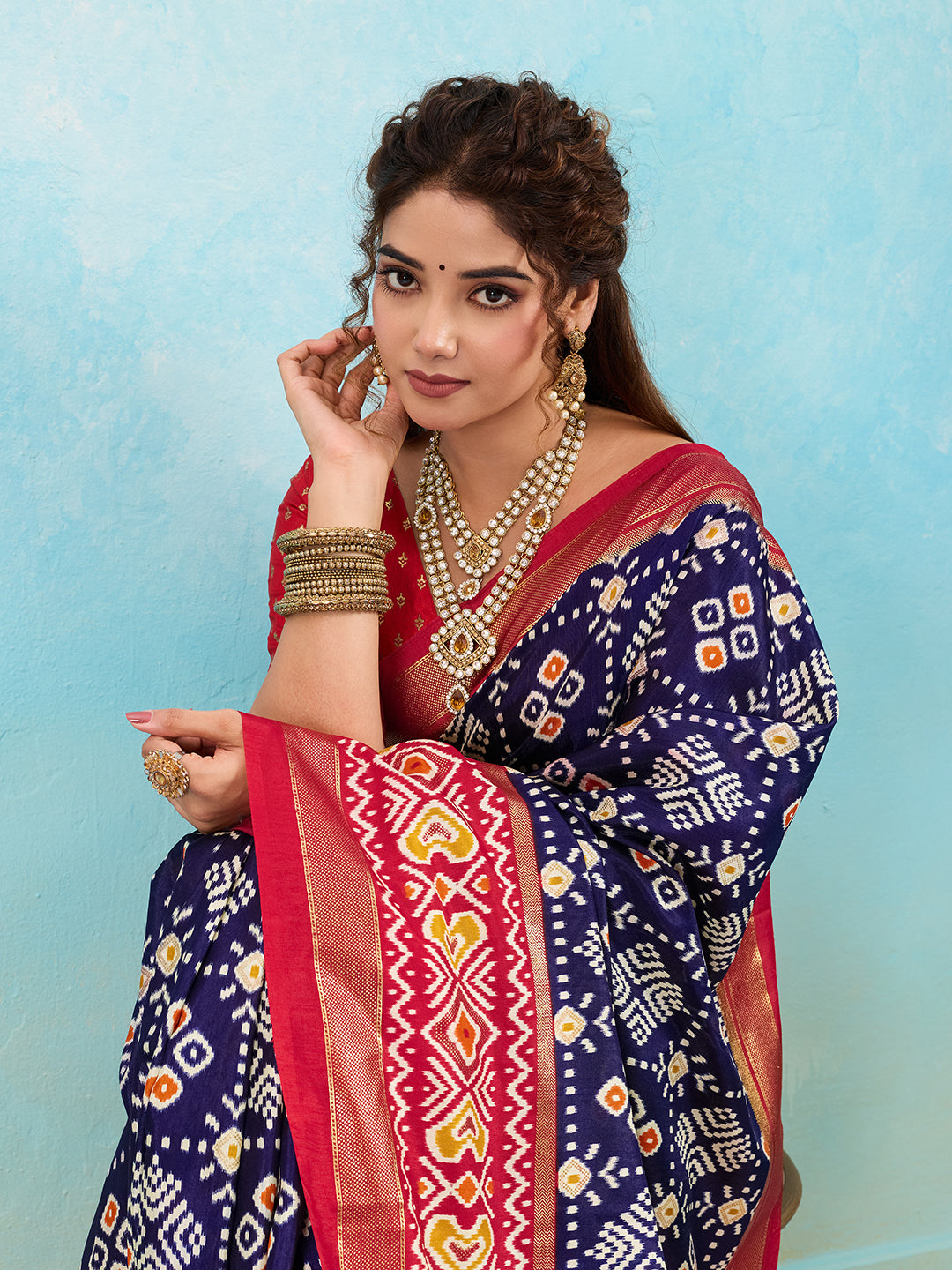 A blue and red pashmina cotton silk saree with a patola style pattern