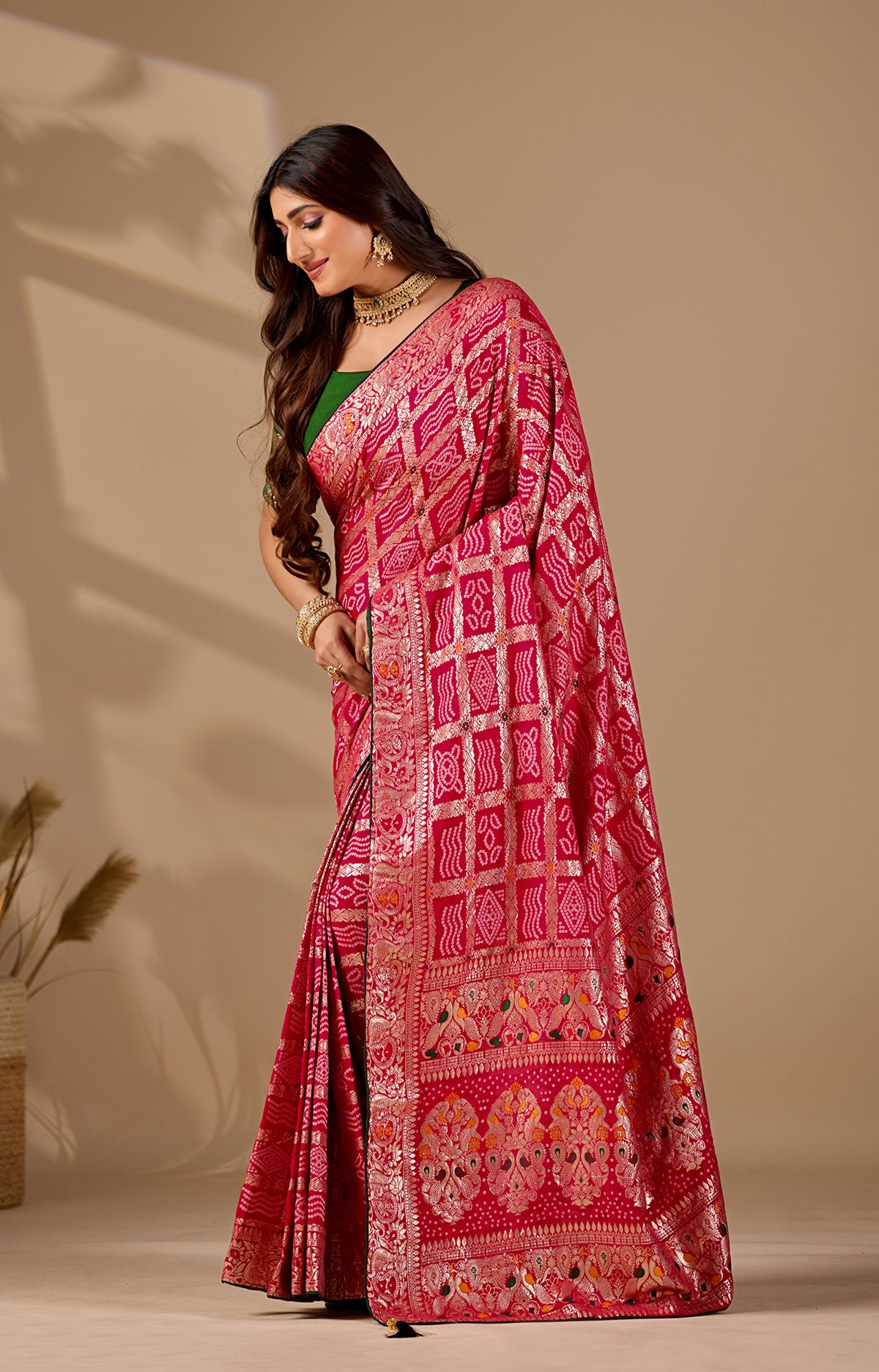 A pink and multicolor bandhani style saree