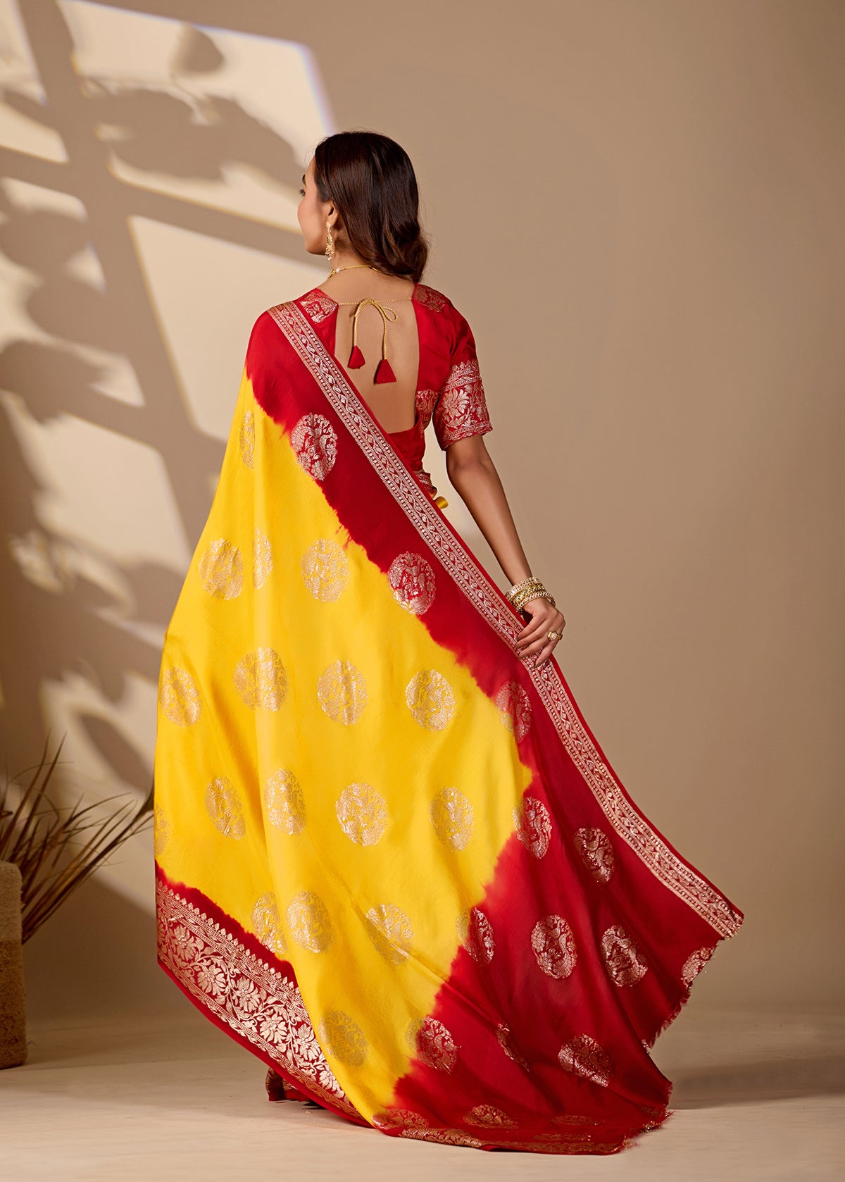 A yellow and red saree withPure Georgette Zari Faag Shadded Saree