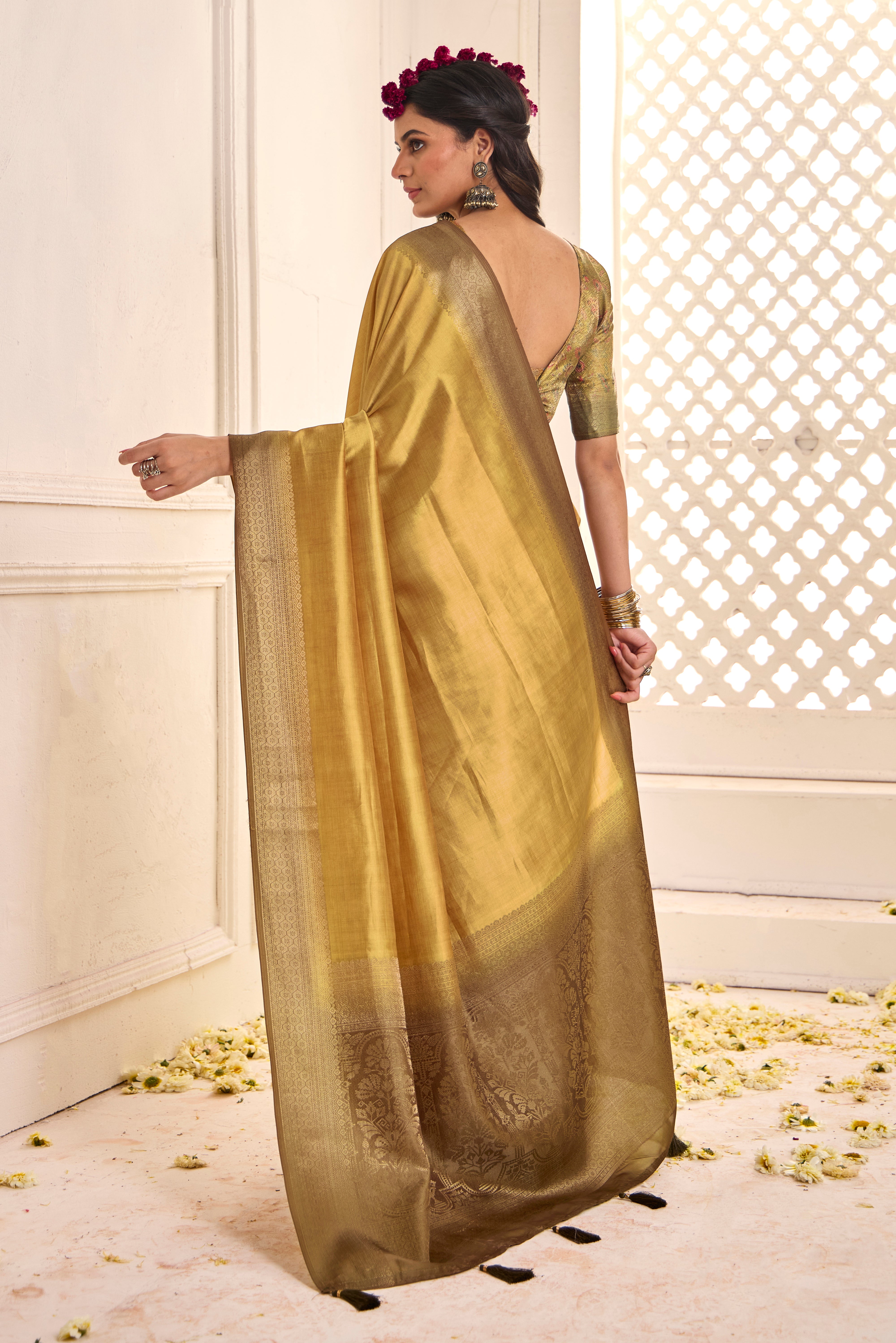 A gold and yellow tissue silk Banarasi style party wear saree