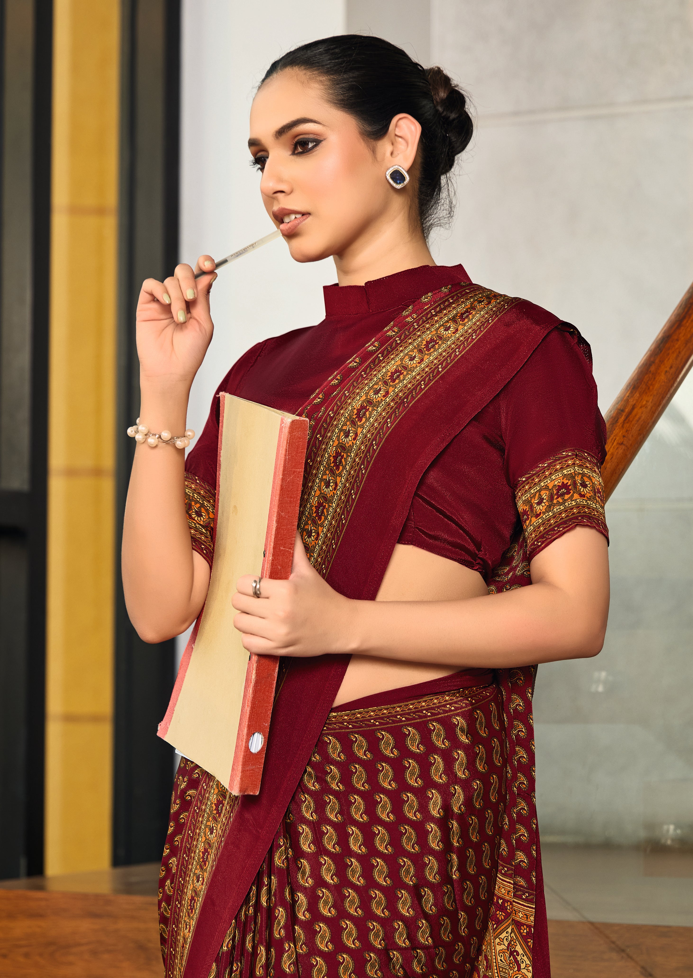 maroon crepe silk saree with a floral pattern under 1500