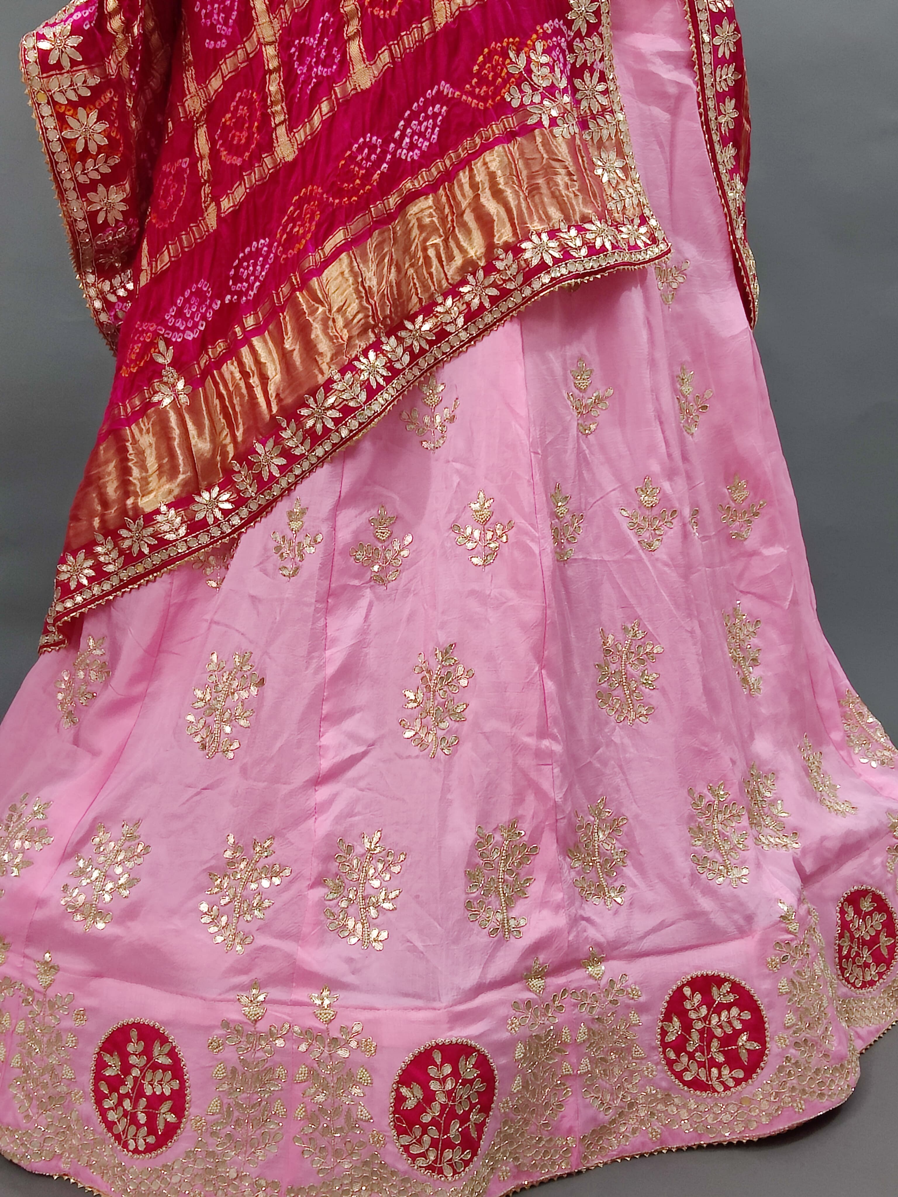 A pink lehenga set with dupatta and gotapati work