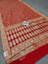 A red georgette saree with gota patti and neemzari bandhej