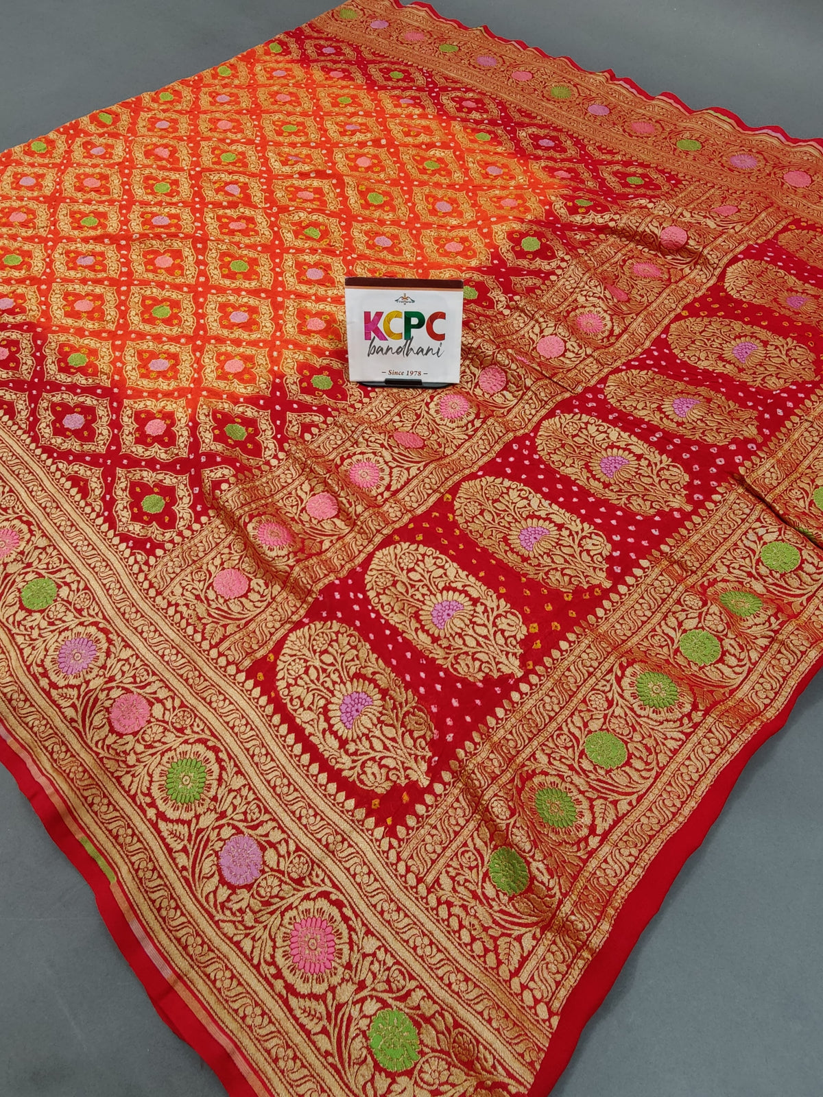 KcPc New Launch Pure Khaddi Georgette Meenakari Neemzari Bandhej DupattaOrange Red