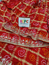 A red silk saree with gota patti work