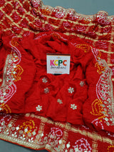 A red silk saree with gota patti work