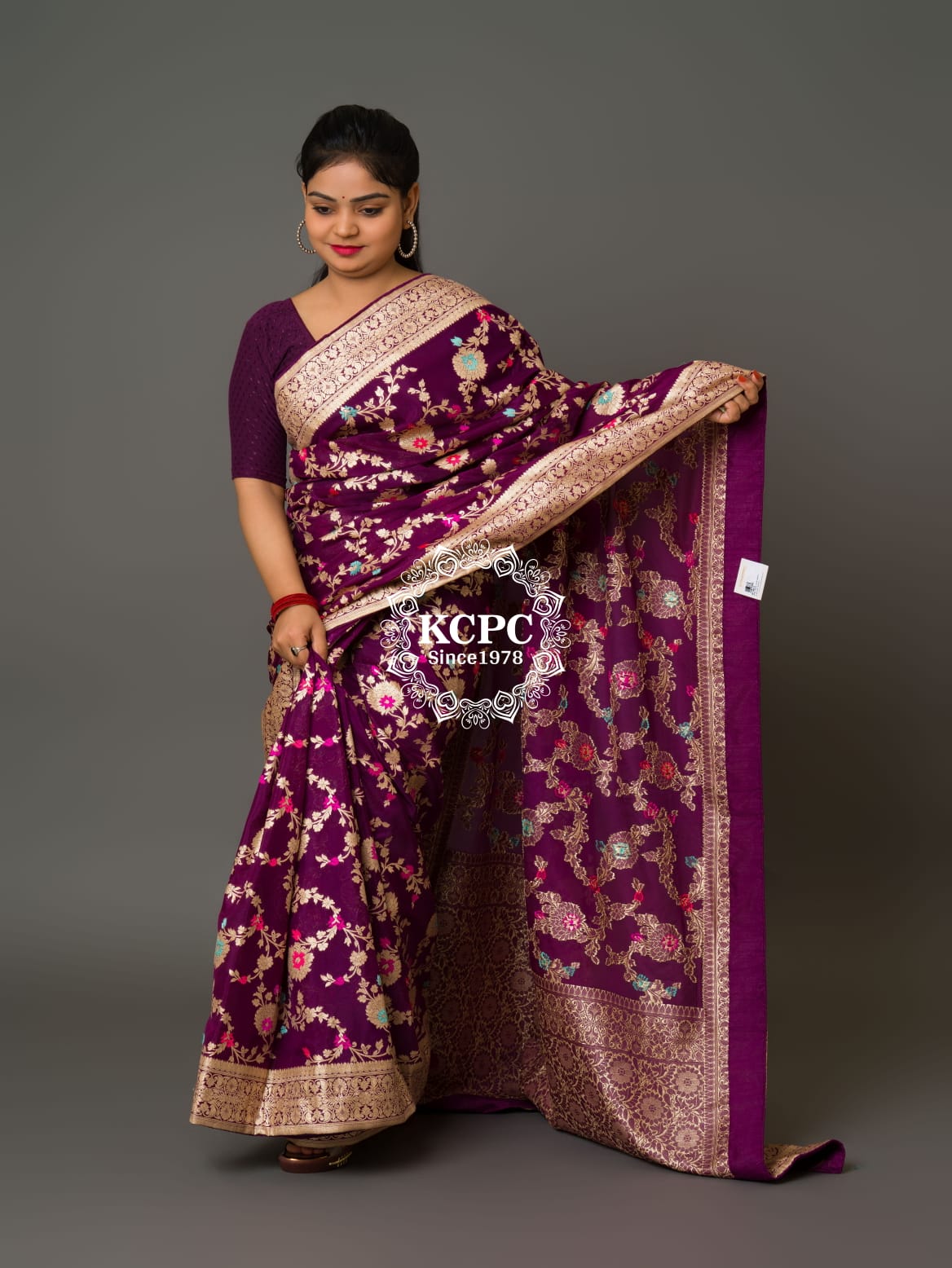 A purple Banarasi saree with floral patterns