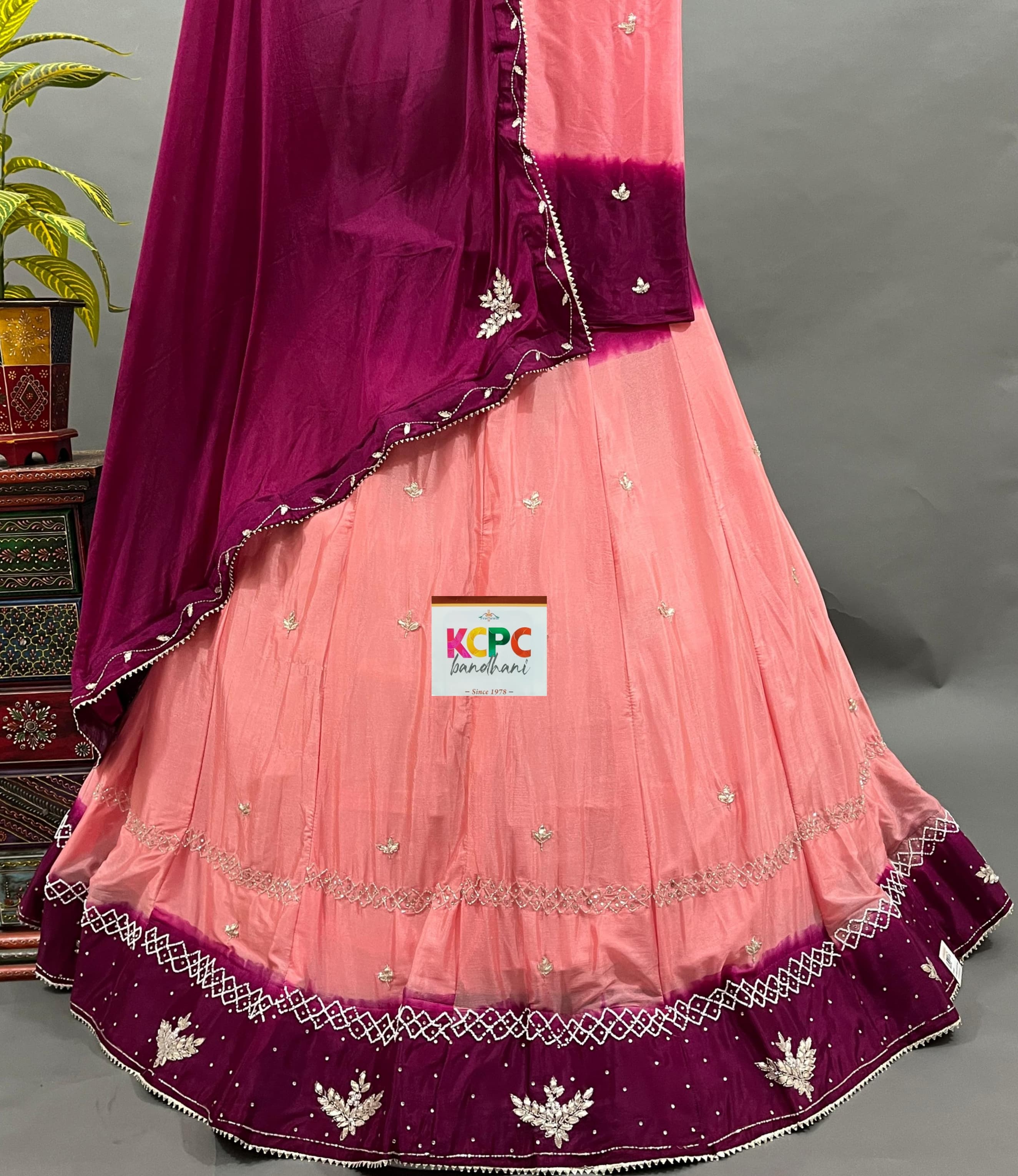 A pink and purple traditional Indian lehenga with cutdana handwork