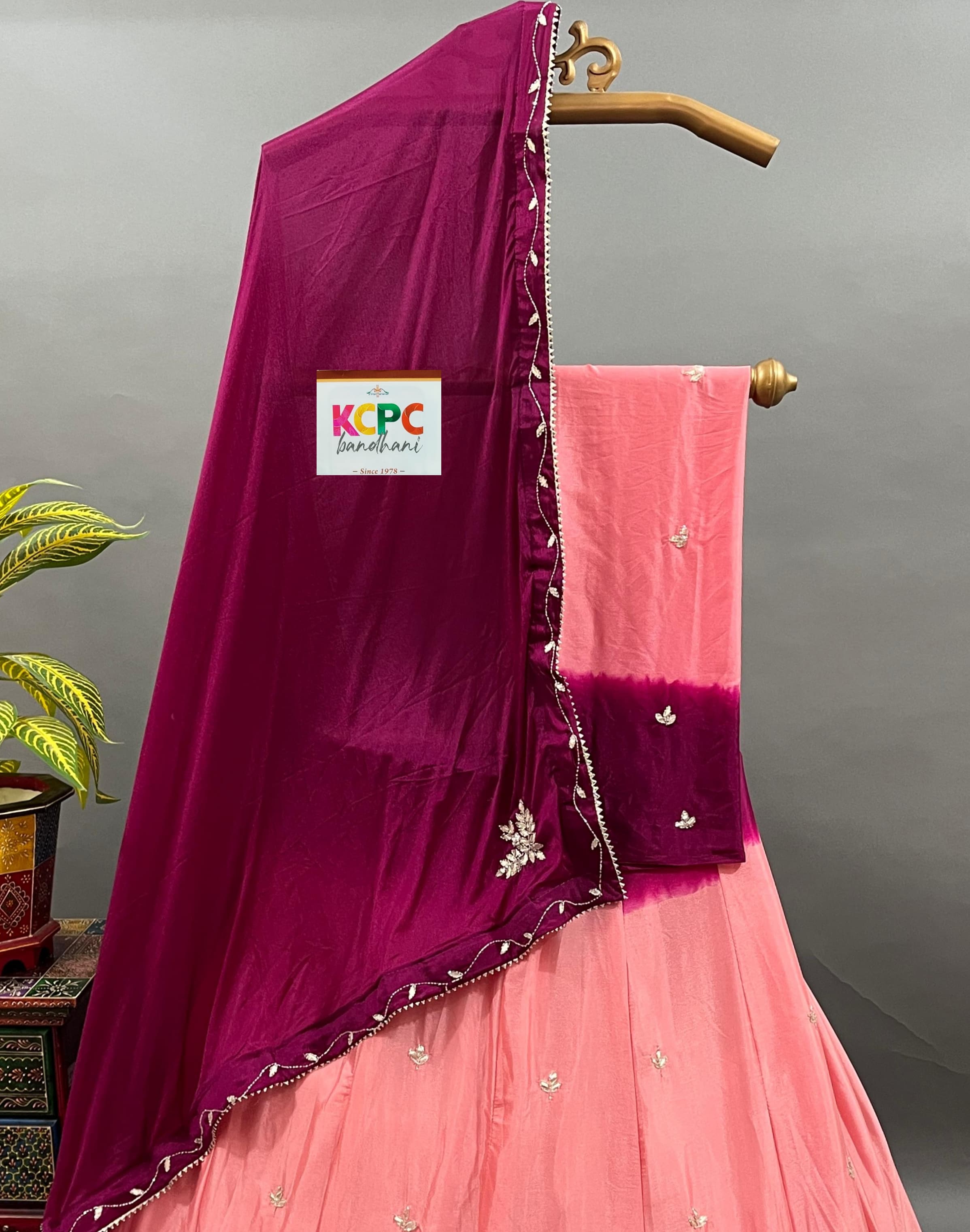 A pink and purple traditional Indian lehenga with cutdana handwork