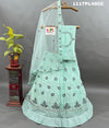 A blue net lehenga set with sequins and embroidery