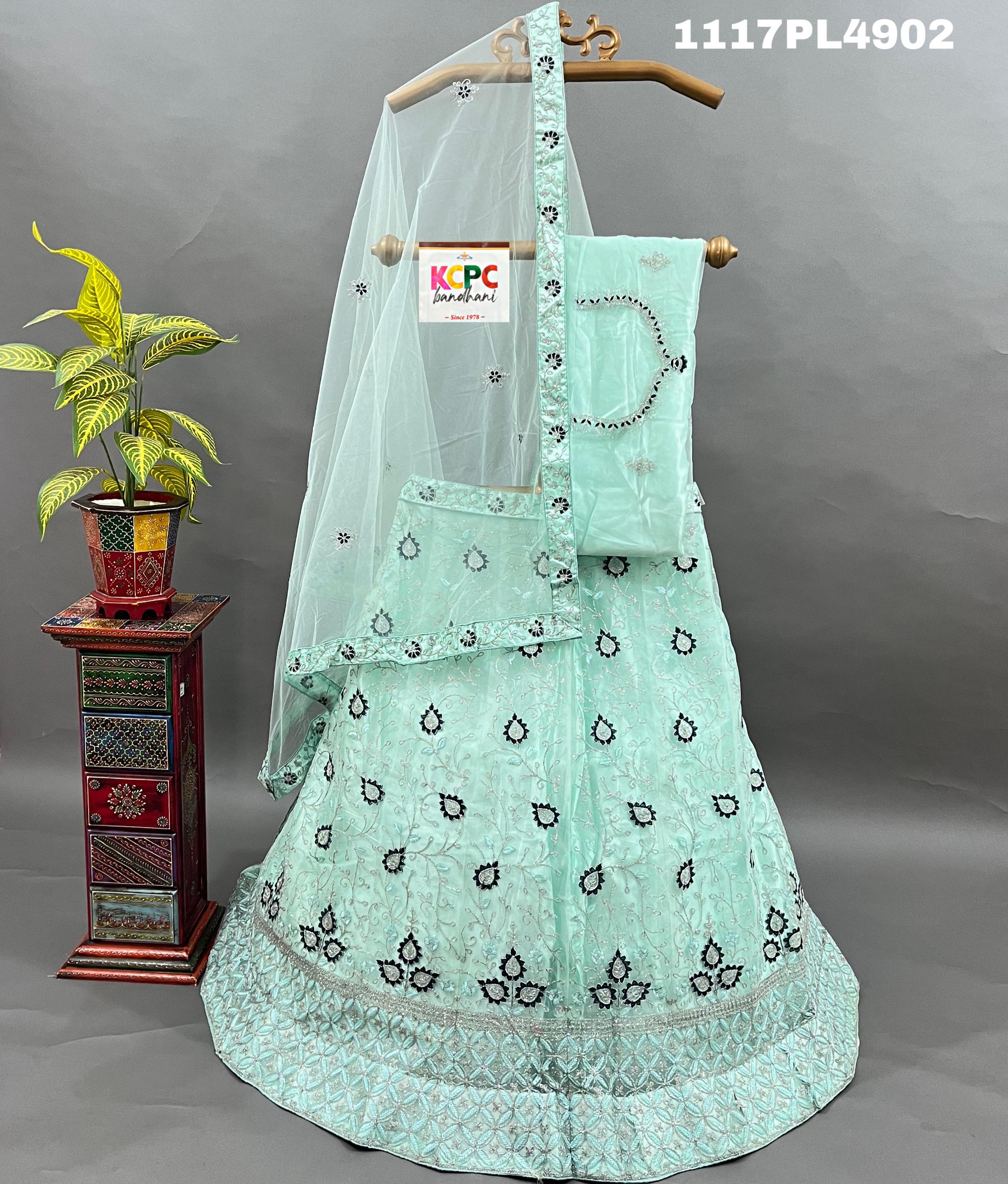 A blue net lehenga set with sequins and embroidery
