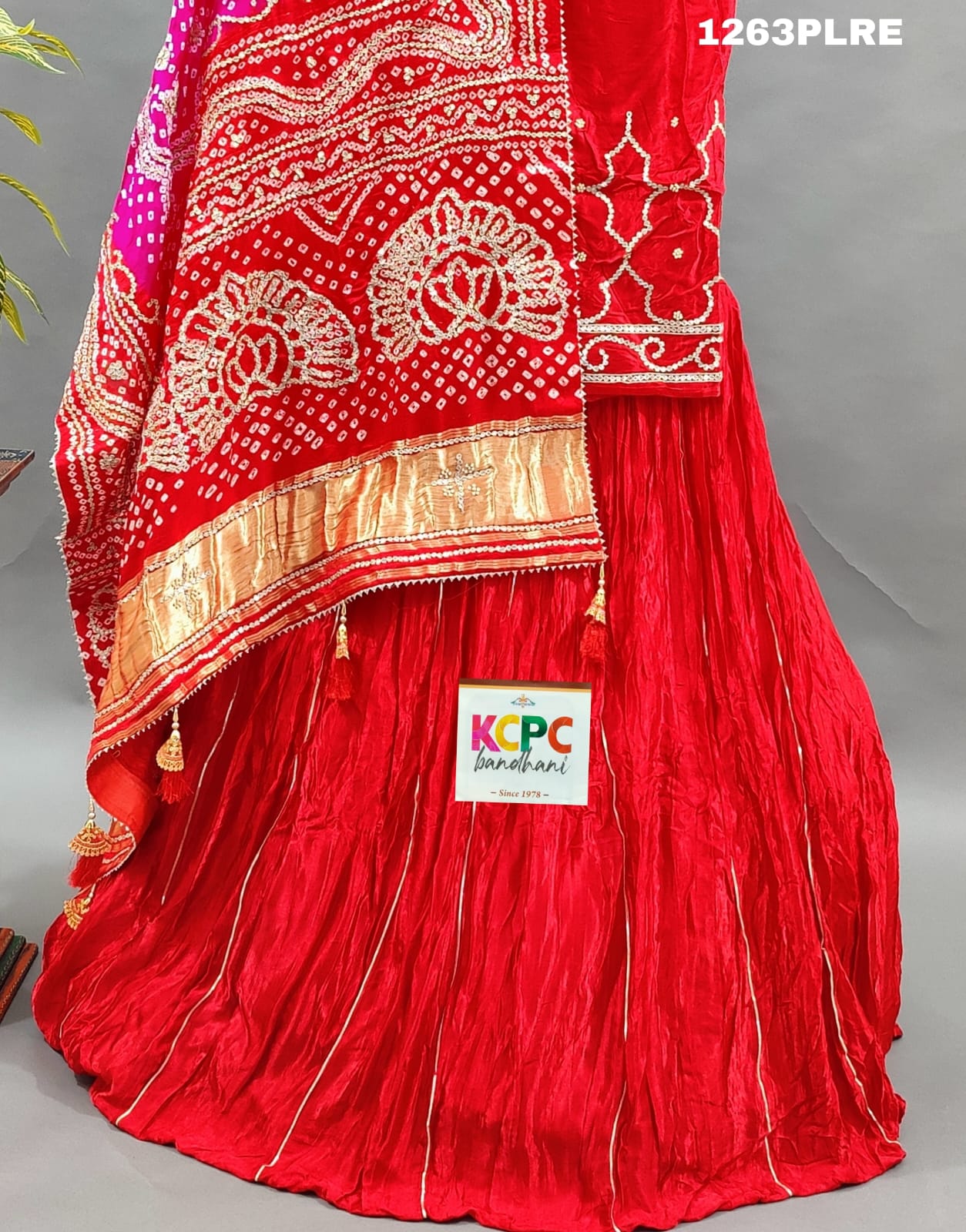A red and pink silk lehenga with bandhani style