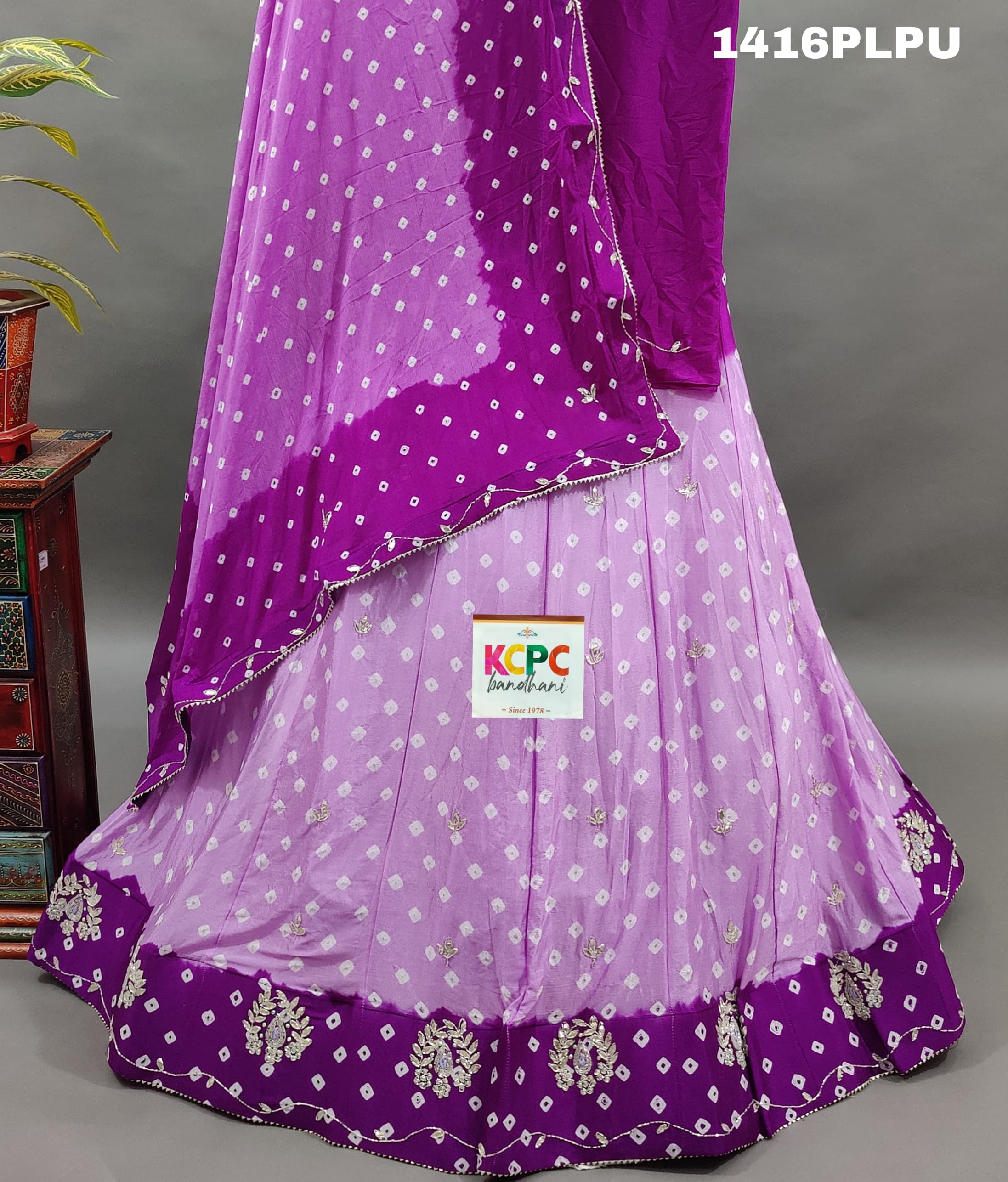 A purple lehenga with double shade bandhani cutdana work