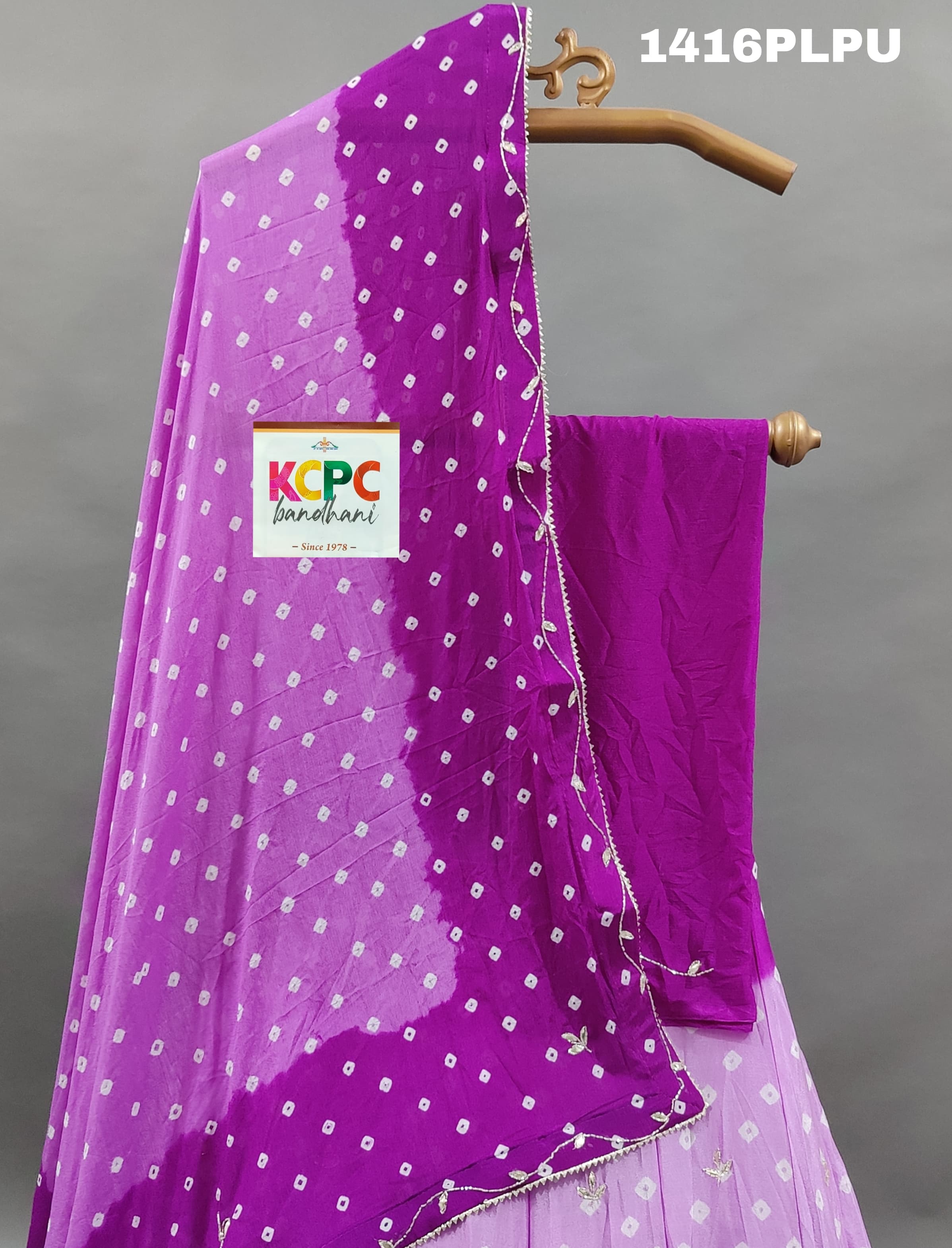 A purple lehenga with double shade bandhani cutdana work