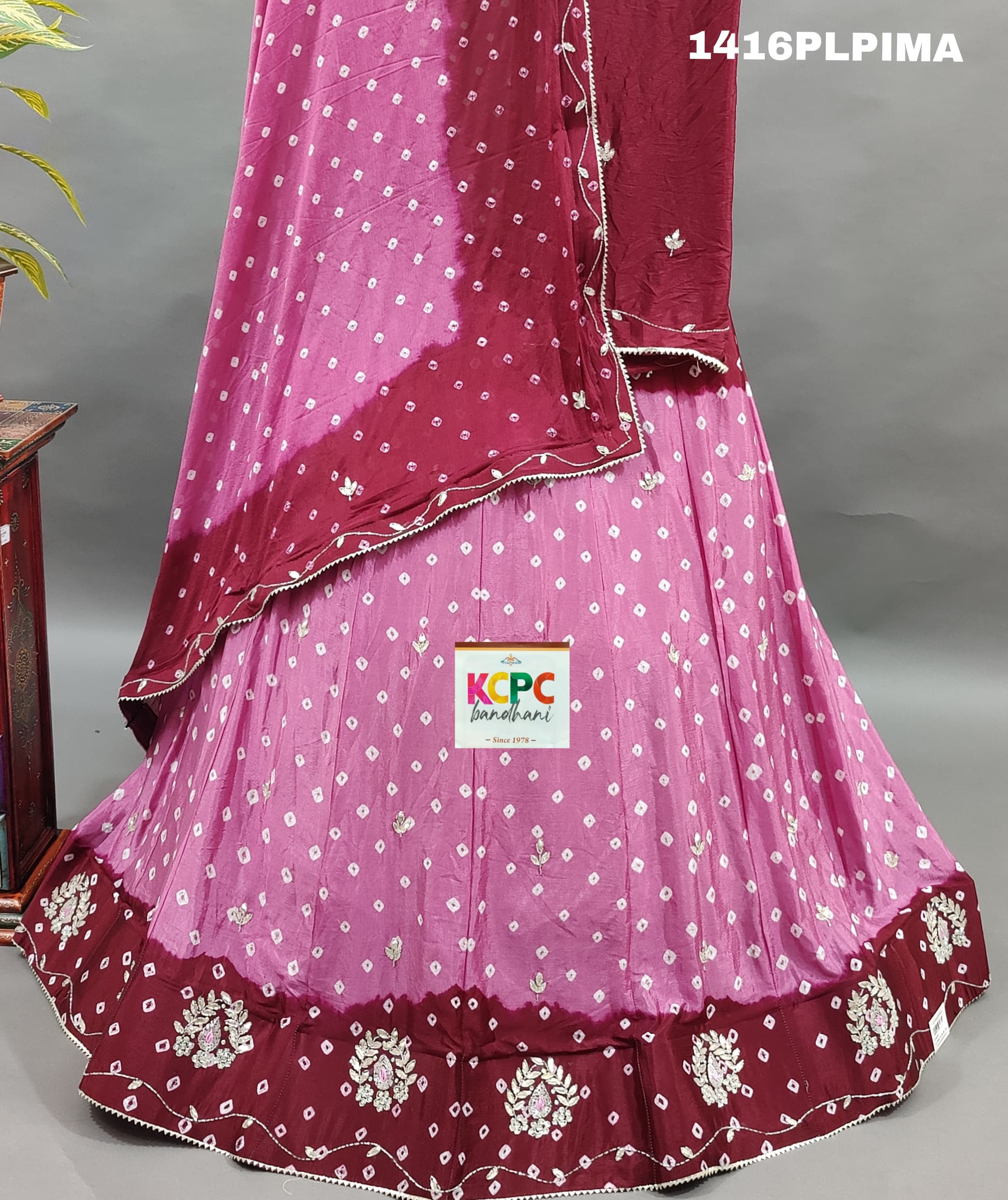 A traditional Indian lehenga set with pink and purple colors