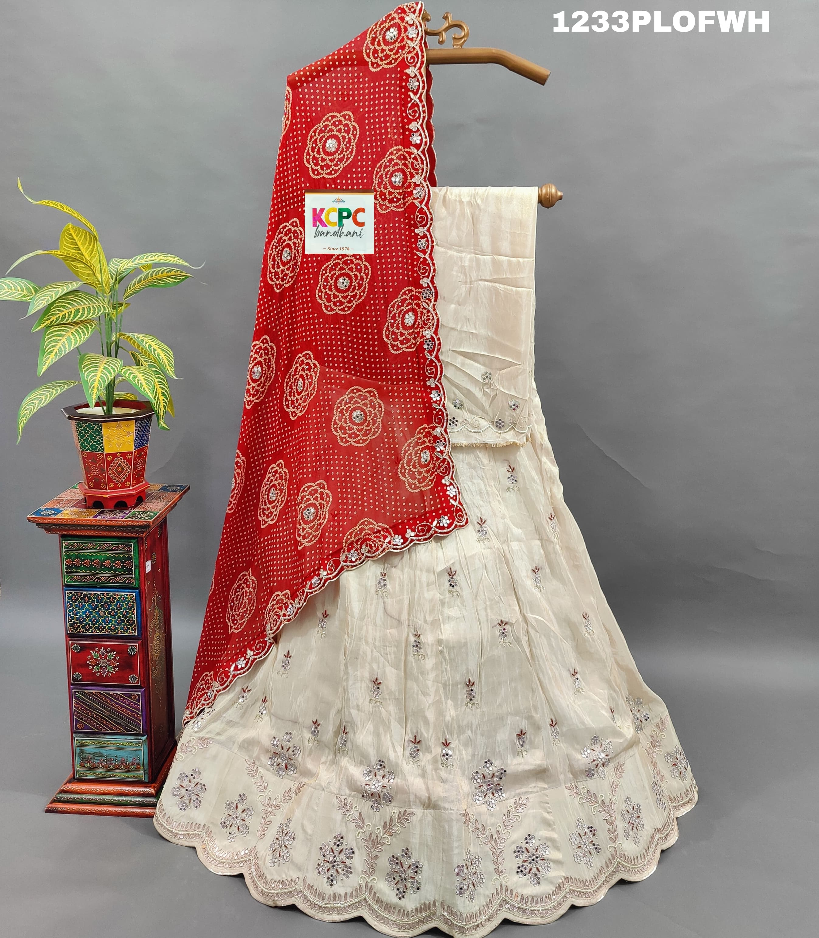A red and white traditional lehenga withmirror work