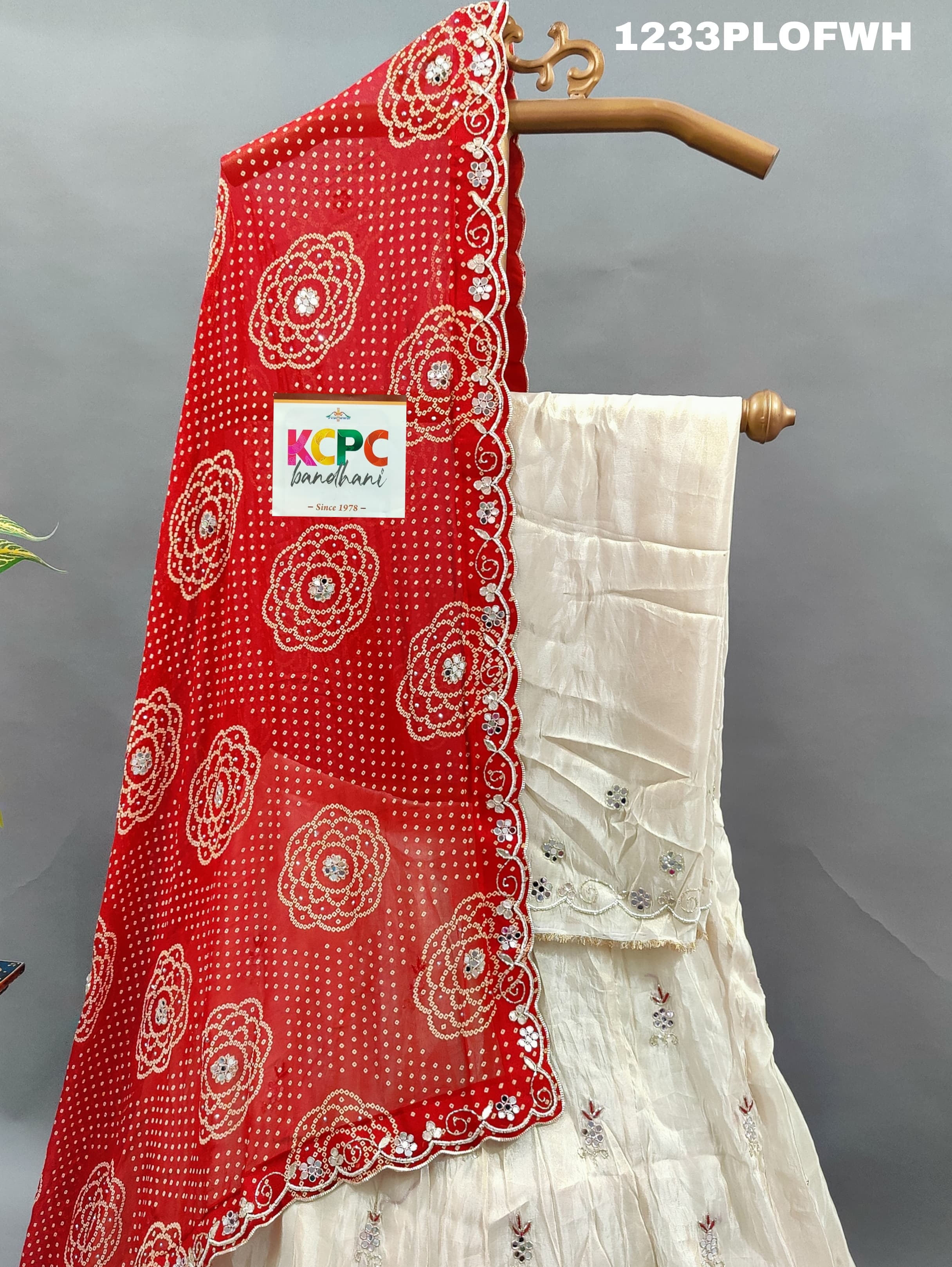 A red and white traditional lehenga withmirror work