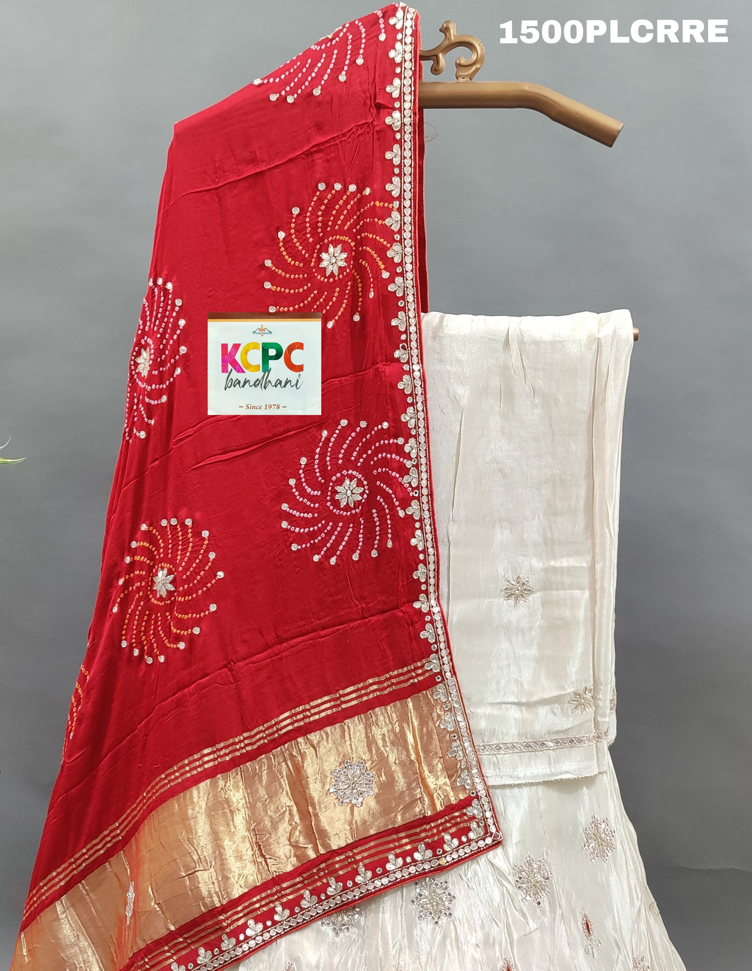 A red and white traditional lehenga with bandhani dupatta and zardoji gotapatti work