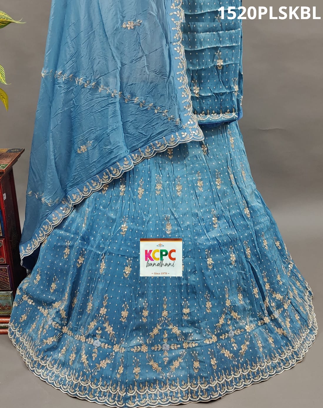 A blue and white traditional lehenga with cutdana beadwork
