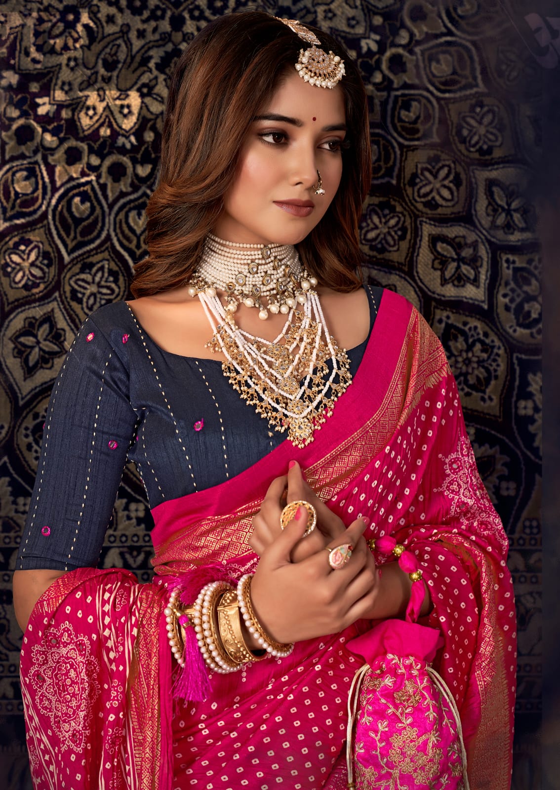 A traditional pink saree with mirror work