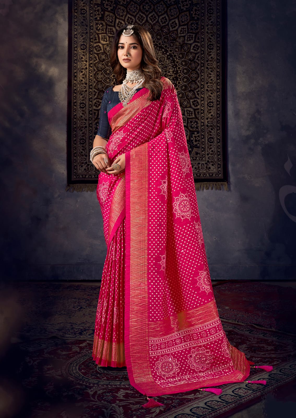 A traditional pink saree with mirror work