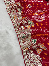 A red bandhani saree with gota patti work
