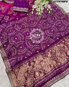 A purple and pink bandhani saree with heavy gotapatti work